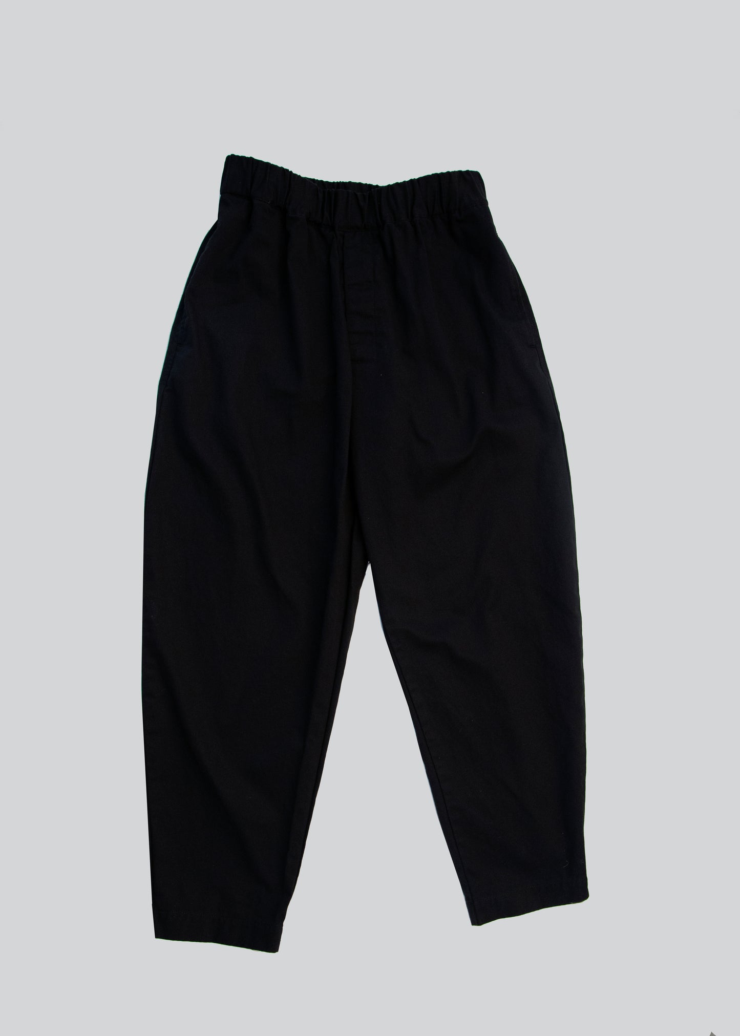 Front flat lay of gathered pants in color black