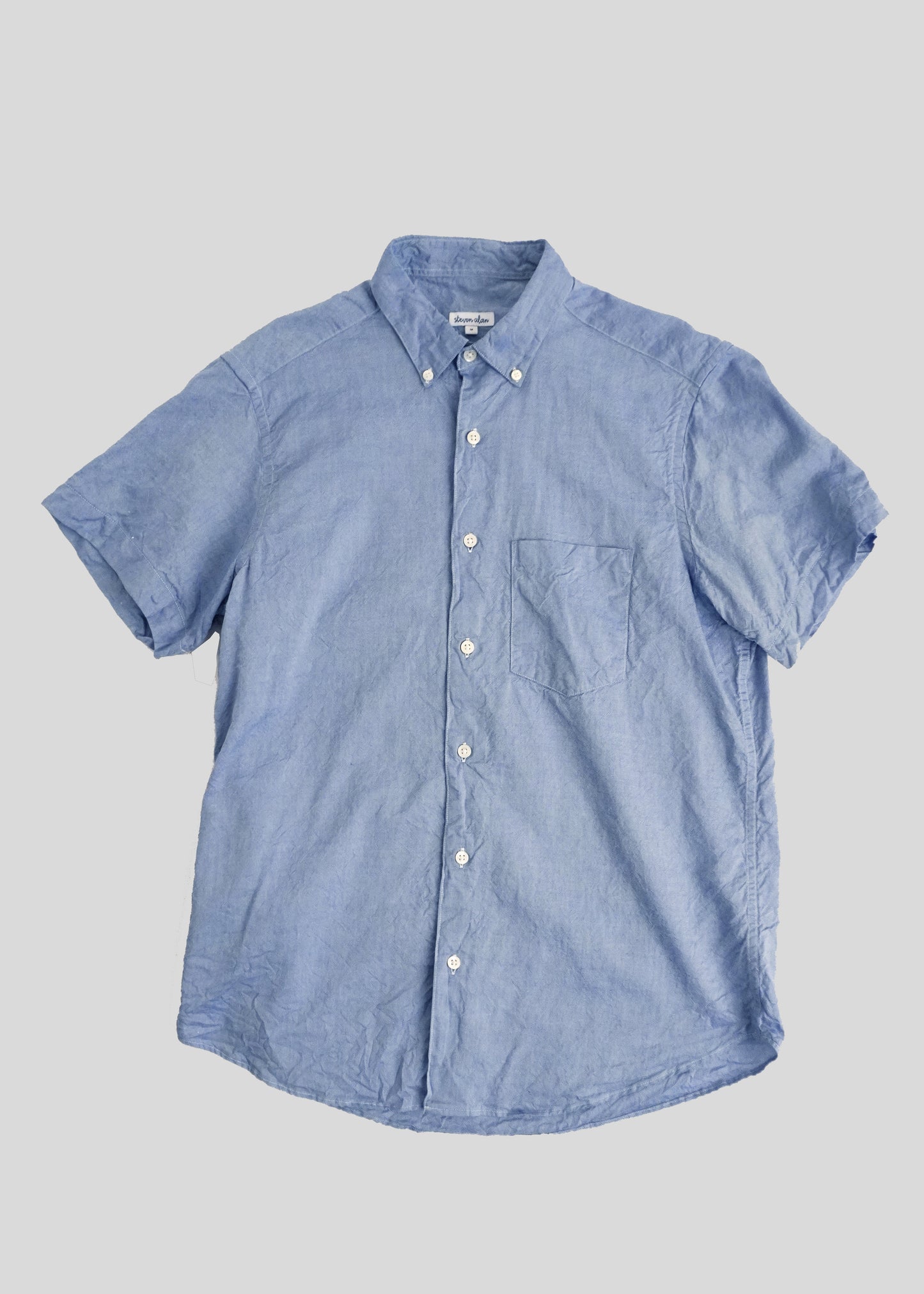 Front flat lay of single needle shirt in light blue crinkle cotton