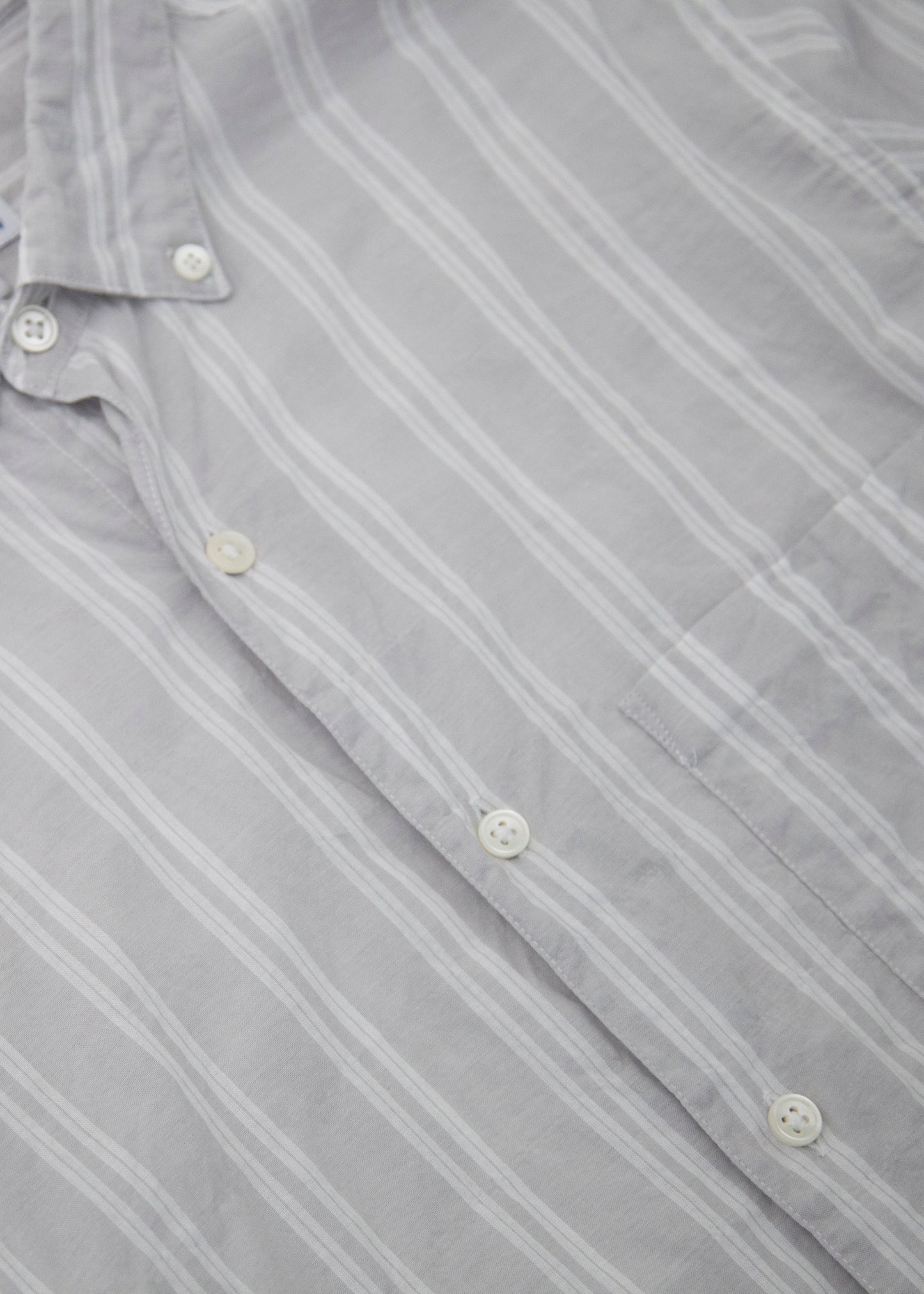 Close up of the single needle shirt in color cream fabric and buttons