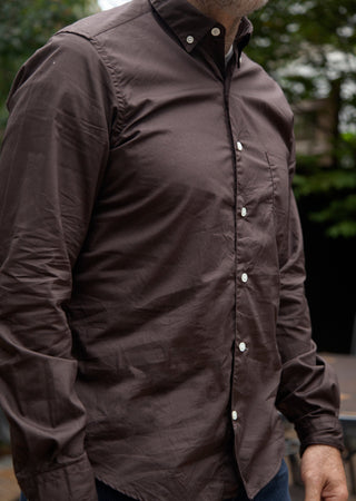 Close up shot of model wearing single needle shirt in dark brown