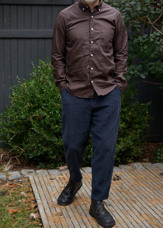 Model wearing single needle shirt in dark brown standing