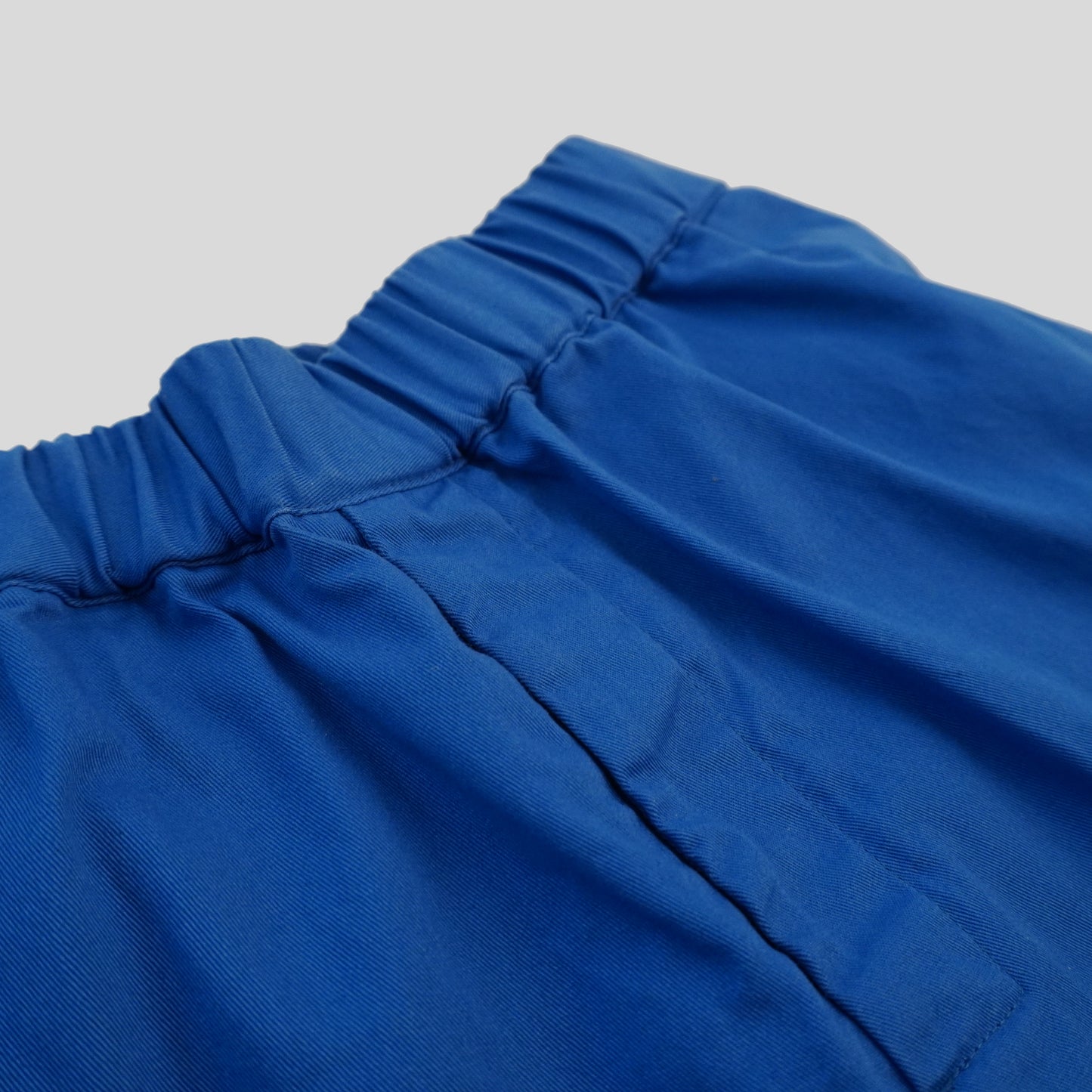 close up shot of front of gathered pants in marine blue