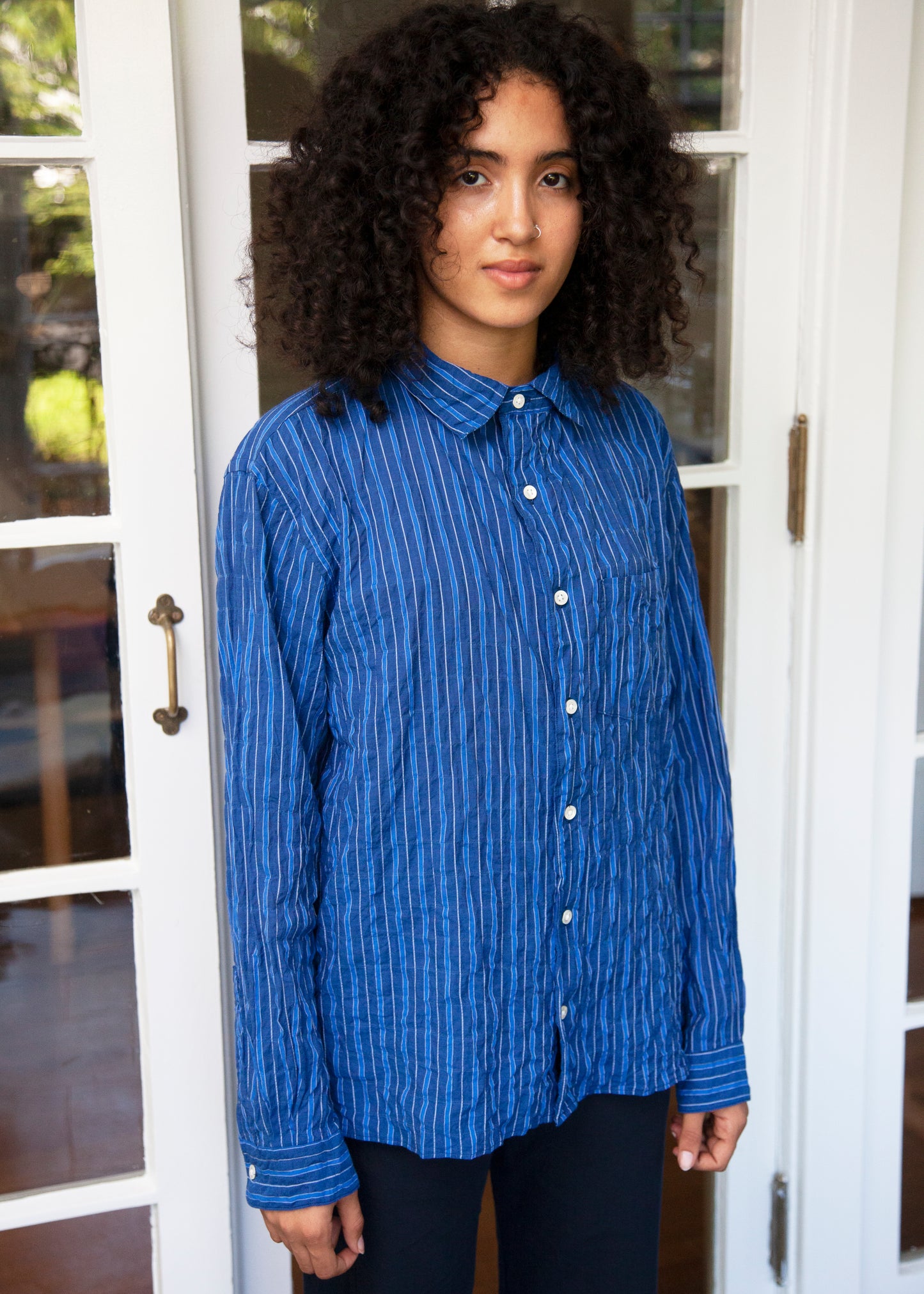 notch shirt in dark blue stripe on female model standing 