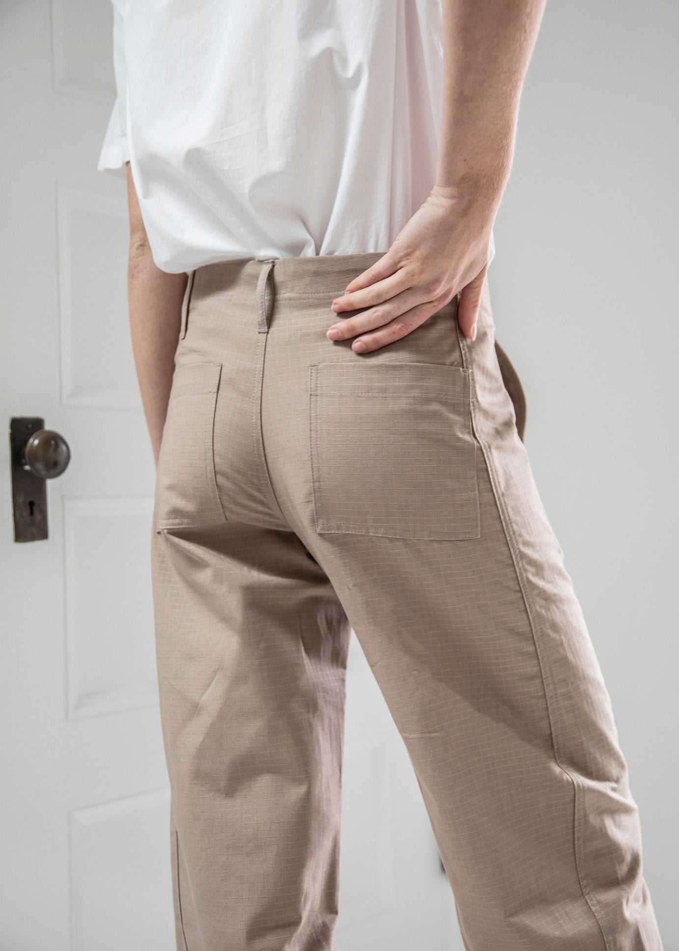 close up of the back of the slacker pants in color khaki on model
