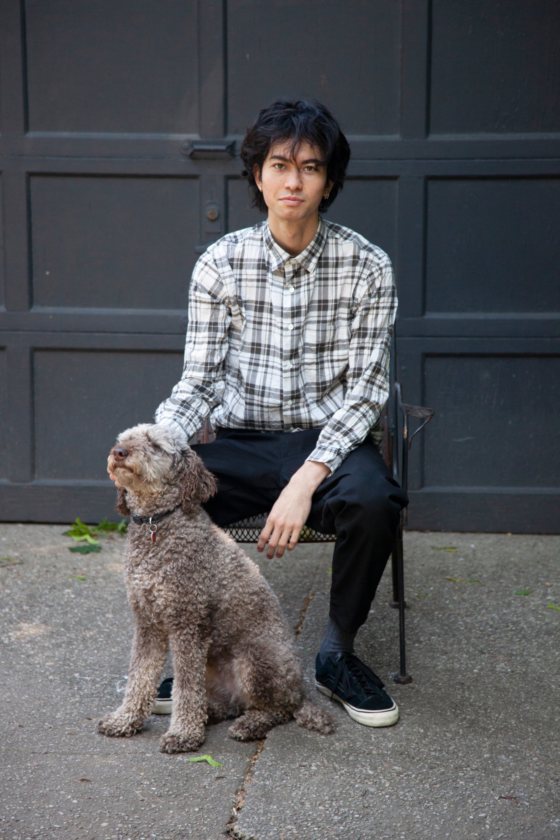 notch shirt in bw check on model sitting down with a dog on the side 
