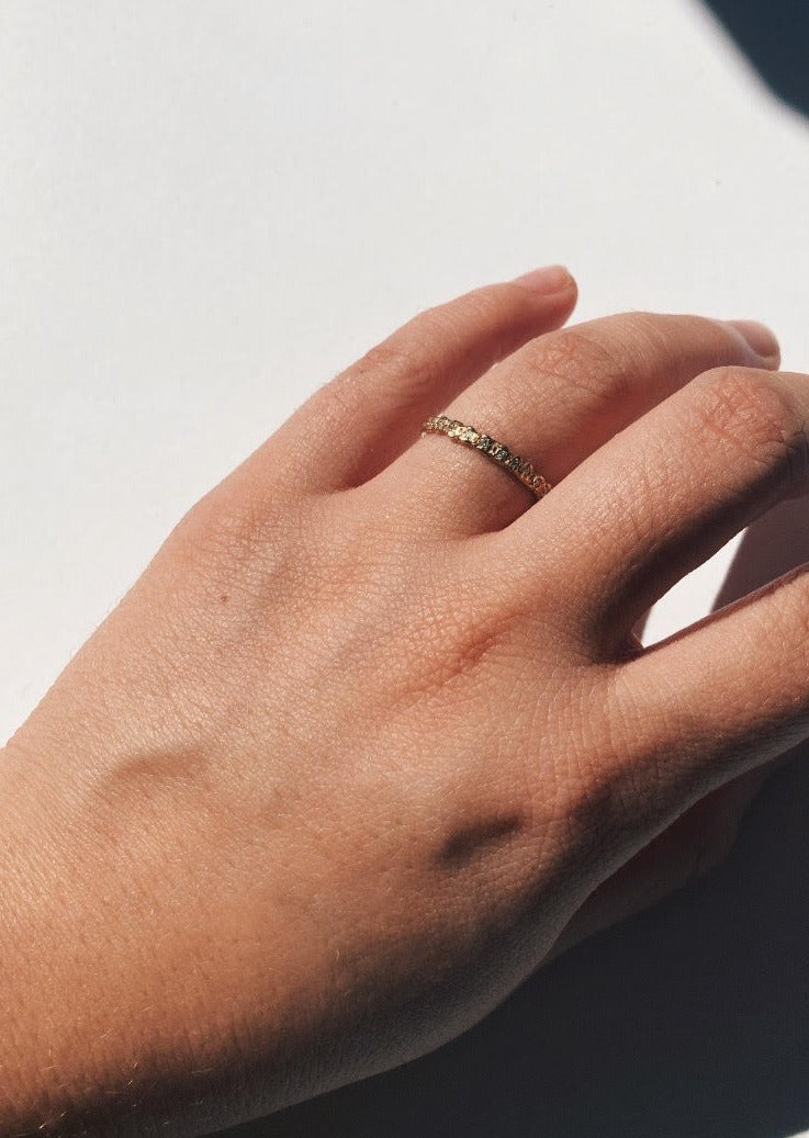 diamond eternity ring on finger, hand close up