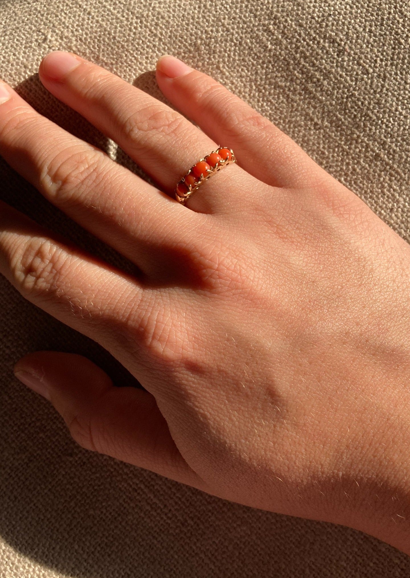 vintage coral gold ring front on model hand close up