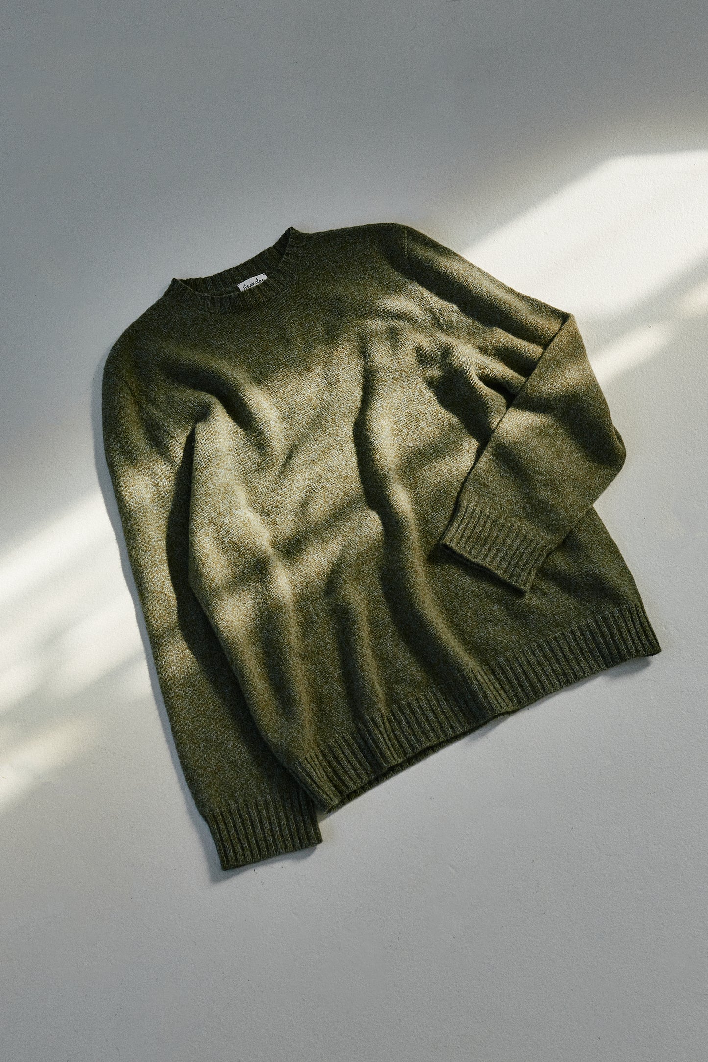 Front flat lay of seamless sweater in color stone green
